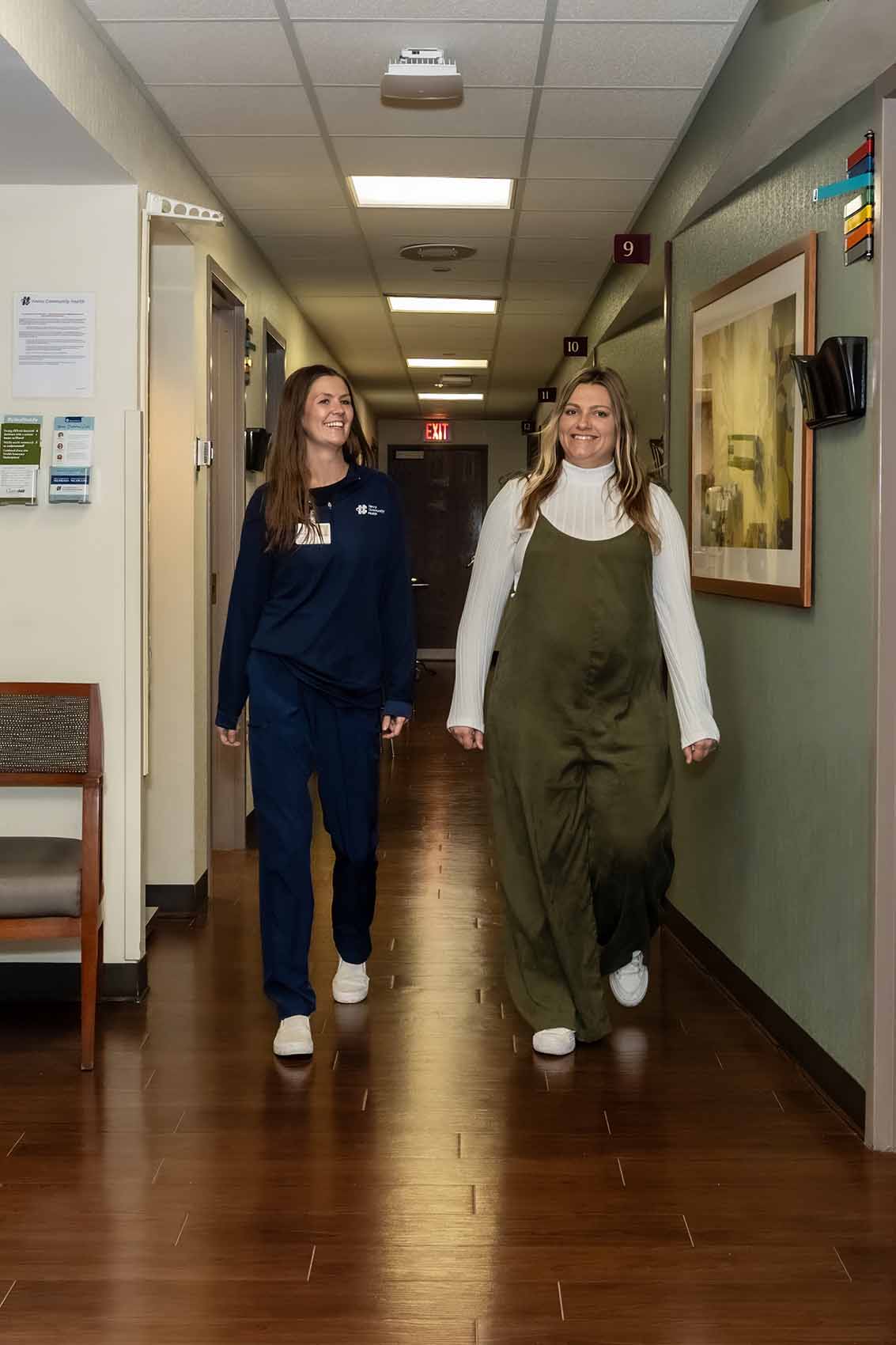 HCH Mom walking down the hall with OB/GYN staff member