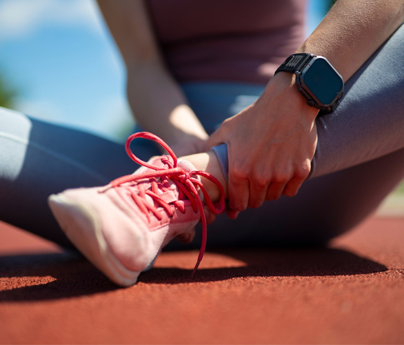 Runner holding her ankle in pain
