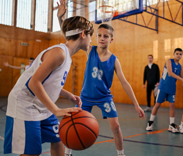 Kids playing competitive basketball