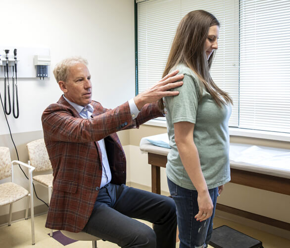 Dr. Scott Taylor examining a patient with back and neck pain