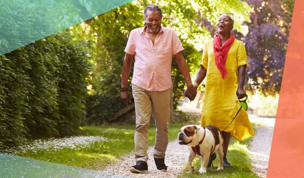 Couple walking their dog wearing bright colors focus on hips