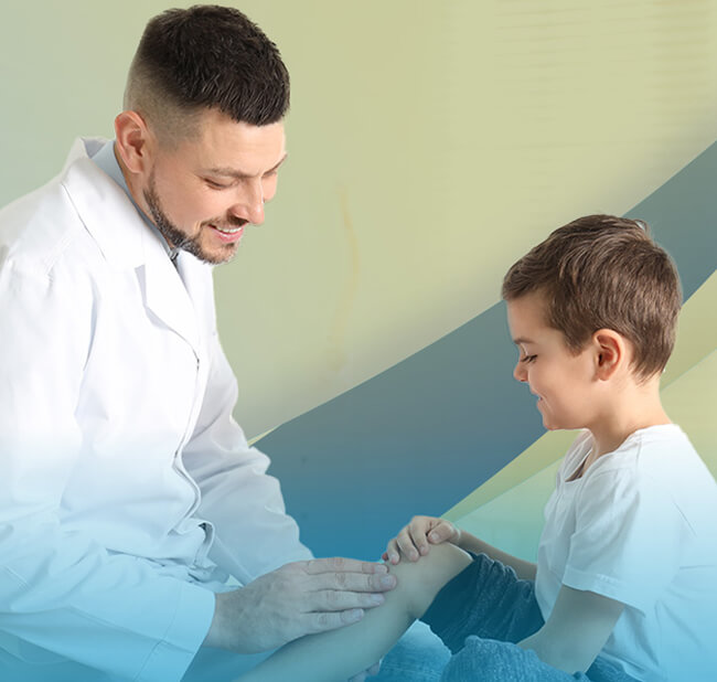 A doctor examining a pediatric patient's hurt knee