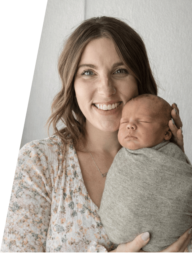 New mom holding up her newborn baby