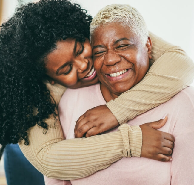 Two generation woman together hugging in promotion of healthy living and breast care