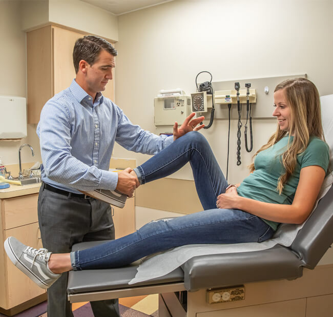 Dr. Strong performing orthopedic knee evaluation