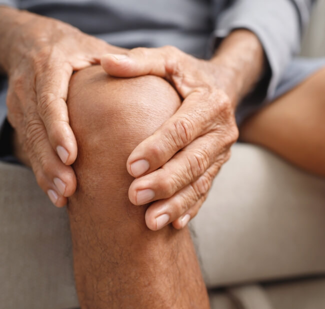 Man holding knee in pain
