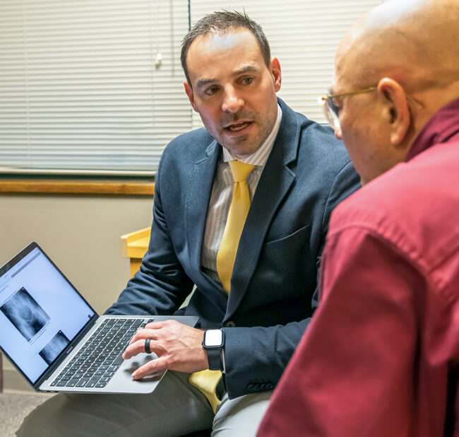 Doctor explaining Persona IQ Smart Knee procedure to patient