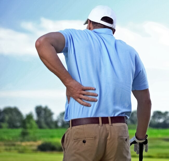 Golfer holding back in pain