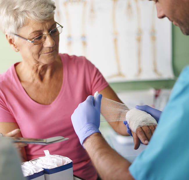 Nurse wrapping patient's wound